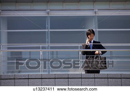 Businessman on cell phone, Shiga Prefecture, Honshu, Japan View Large Photo Image Stock Image - Businessman on cell phone, Shiga Prefecture, Honshu, Japan. Fotosearch