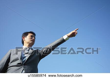 Businessman Pointing, Low Angle View View Large Photo Image Picture - Businessman Pointing, Low Angle View. Fotosearch