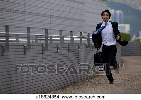 Picture - Businessman running, Shiga Prefecture, Honshu, Japan. Fotosearch