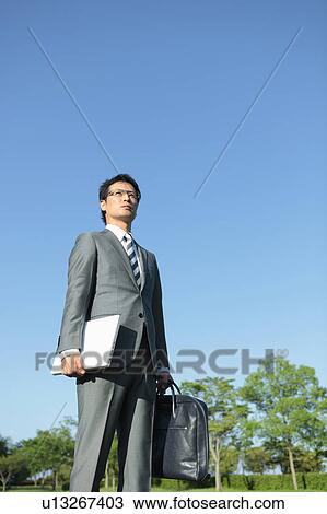 Businessman with Laptop and Briefcase View Large Photo Image Stock Image - Businessman with Laptop and Briefcase. Fotosearch