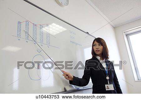 Stock Image - Businesswoman in a meeting, Shiga Prefecture, Honshu, Japan. Fotosearch