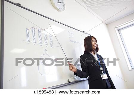 Stock Image - Businesswoman in a meeting, Shiga Prefecture, Honshu, Japan. Fotosearch