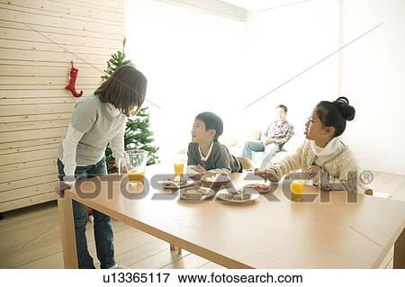 Stock Photo - Children and Mother at Dining Table. Fotosearch