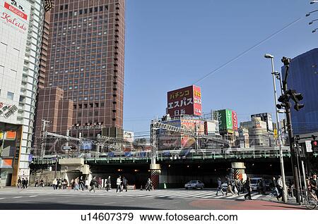 Stock Photo - Commuters Crossing Street at Shinjuku West Entrance. Fotosearch