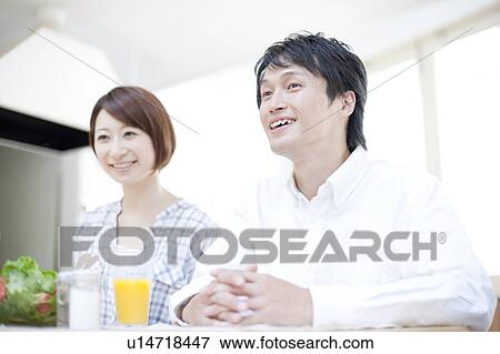 Couple sitting at dining table, Hyogo Prefecture, Honshu, Japan View Large Photo Image Stock Photo - Couple sitting at dining table, Hyogo Prefecture, Honshu, Japan. Fotosearch