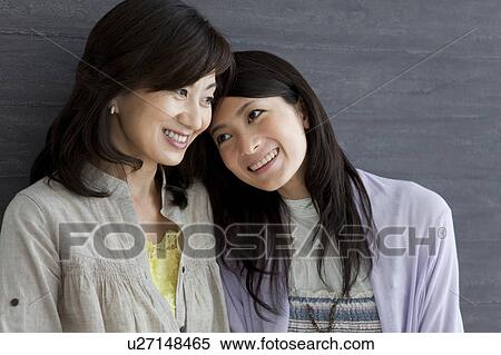 Daughter leaning on mother View Large Photo Image Stock Photography - Daughter leaning on mother. Fotosearch