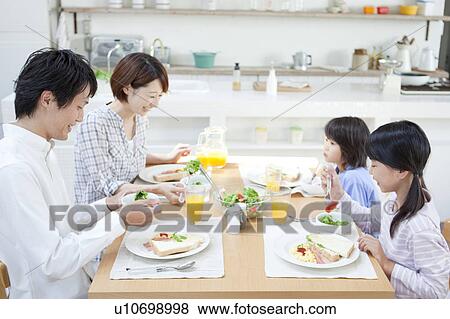 Stock Photo - Family eating breakfast, Hyogo Prefecture, Honshu, Japan. Fotosearch