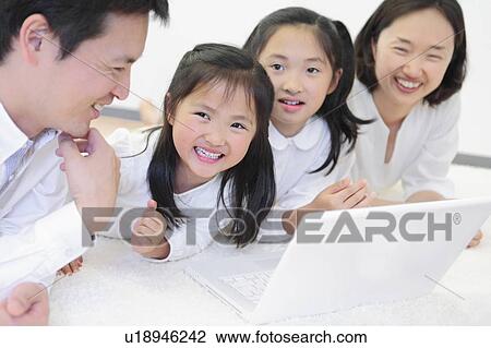 Family of Four Using Laptop View Large Photo Image Stock Image - Family of Four Using Laptop. Fotosearch