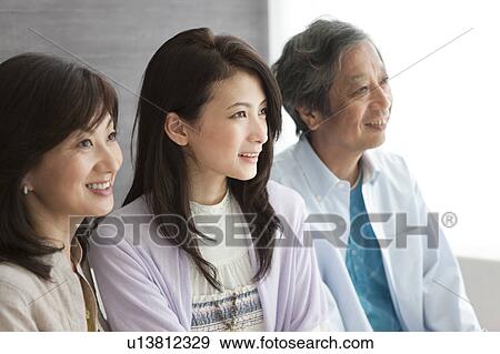 Family sitting on sofa View Large Photo Image Stock Photo - Family sitting on sofa. Fotosearch