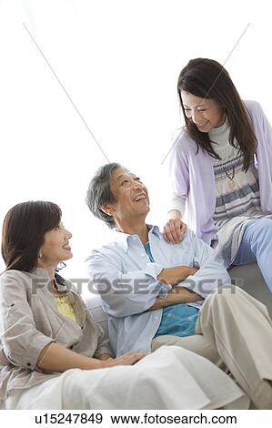 Family sitting on sofa View Large Photo Image Stock Photo - Family sitting on sofa. Fotosearch