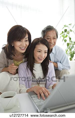 Family using laptop View Large Photo Image Picture - Family using laptop. Fotosearch