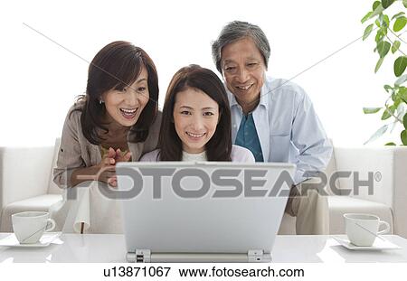 Family using laptop View Large Photo Image Stock Photo - Family using laptop. Fotosearch