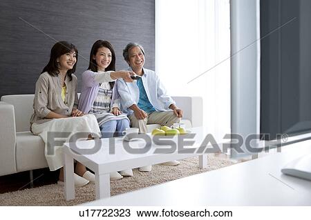 Family watching television View Large Photo Image Stock Image - Family watching television. Fotosearch