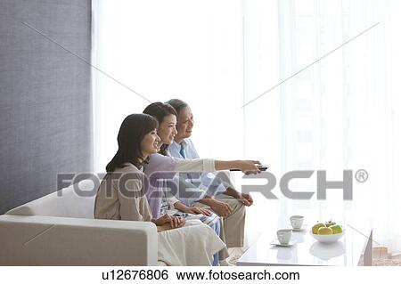 Family watching television View Large Photo Image Stock Photograph - Family watching television. Fotosearch