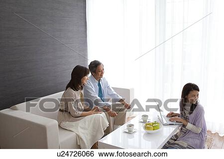 Stock Photograph - Family watching television. Fotosearch