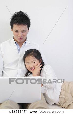 Father and Daughter Using Laptop View Large Photo Image Picture - Father and Daughter Using Laptop. Fotosearch