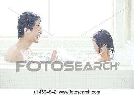 Stock Image - Father and son taking a bath, Hyogo Prefecture, Honshu, Japan. Fotosearch