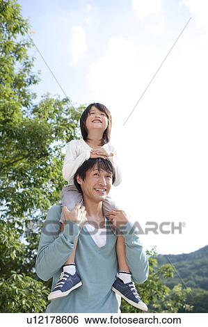Stock Photograph - Father carrying son on the shoulders. Fotosearch