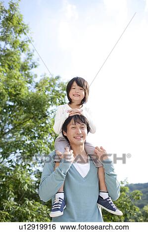 Father carrying son on the shoulders View Large Photo Image Stock Photograph - Father carrying son on the shoulders. Fotosearch