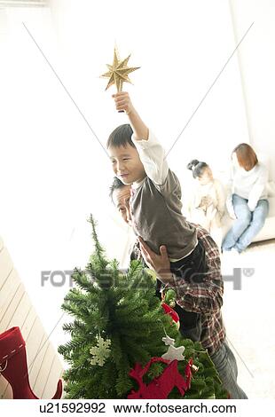 Father Helping Son To Put Star on Christmas Tree View Large Photo Image Stock Image - Father Helping Son To Put Star on Christmas Tree. Fotosearch