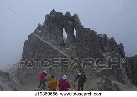 Stock Photograph - Four Hikers at Mountain Top. Fotosearch