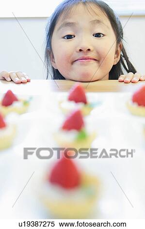 Stock Photography - Girl and Cakes. Fotosearch