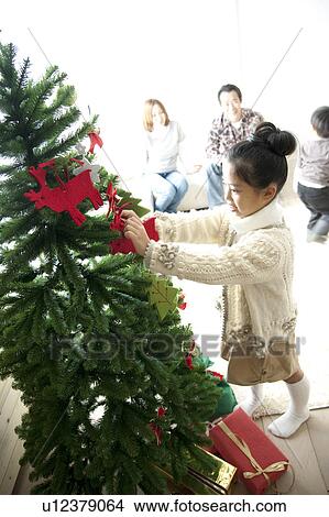 Girl Decorating Christmas Tree View Large Photo Image Picture - Girl Decorating Christmas Tree. Fotosearch