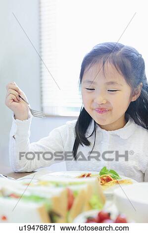 Stock Image - Girl Eating. Fotosearch