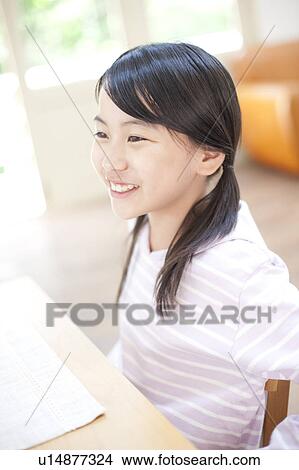 Picture - Girls sitting in a chair, Hyogo Prefecture, Honshu, Japan. Fotosearch