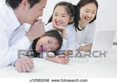 Happy Family Using Laptop View Large Photo Image Stock Photo - Happy Family Using Laptop. Fotosearch