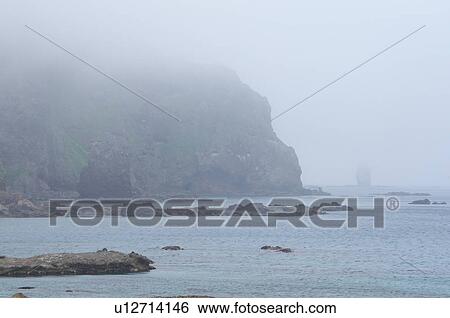 Stock Photograph - Kamui rock and fog, Hokkaido Prefecture, Japan. Fotosearch