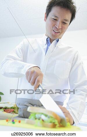 Man Cutting Sandwiches View Large Photo Image Stock Photograph - Man Cutting Sandwiches. Fotosearch