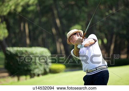 Picture - Man playing golf, Miyazaki Prefecture, Kyushu, Japan. Fotosearch