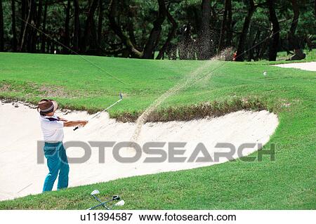 Stock Photo - Man playing golf, Miyazaki Prefecture, Kyushu, Japan. Fotosearch