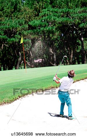 Stock Photo - Man playing golf, Miyazaki Prefecture, Kyushu, Japan. Fotosearch