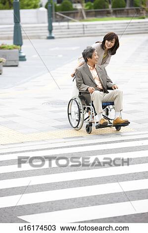 Mature woman talking to senior man on wheelchair View Large Photo Image Stock Image - Mature woman talking to senior man on wheelchair. Fotosearch