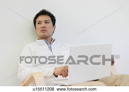 Mid Adult Man Using Laptop View Large Photo Image Stock Photo - Mid Adult Man Using Laptop. Fotosearch