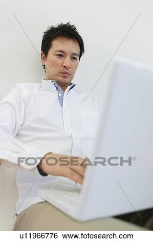 Mid Adult Man Using Laptop View Large Photo Image Stock Photograph - Mid Adult Man Using Laptop. Fotosearch