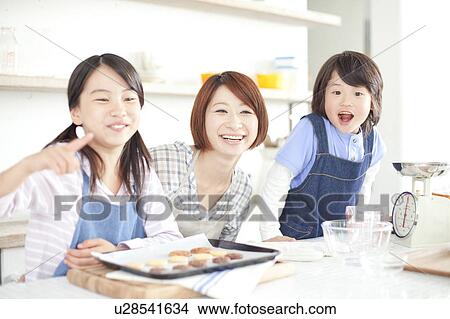 Picture - Mother and children baking together, Hyogo Prefecture, Honshu, Japan. Fotosearch