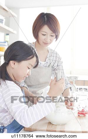 Mother and daughter in kitchen baking, Hyogo Prefecture, Honshu, Japan View Large Photo Image Picture - Mother and daughter in kitchen baking, Hyogo Prefecture, Honshu, Japan. Fotosearch