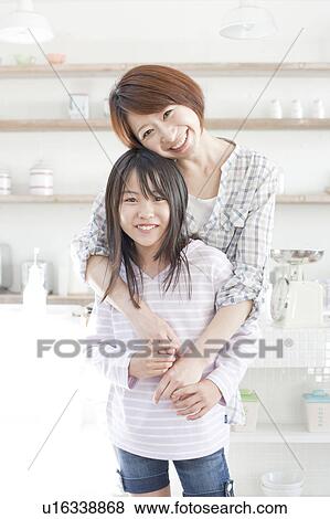 Mother and daughter in kitchen, Hyogo Prefecture, Honshu, Japan View Large Photo Image Stock Photo - Mother and daughter in kitchen, Hyogo Prefecture, Honshu, Japan. Fotosearch