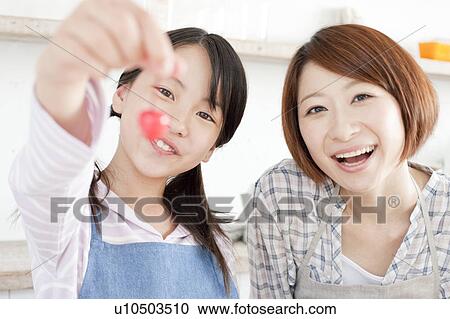 Mother and daughter in kitchen decorating cake, Hyogo Prefecture, Honshu, Japan View Large Photo Image Stock Image - Mother and daughter in kitchen decorating cake, Hyogo Prefecture, Honshu, Japan. Fotosearch