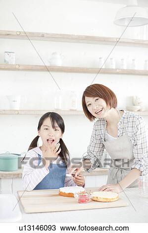 Mother and daughter in kitchen decorating cake, Hyogo Prefecture, Honshu, Japan View Large Photo Image Stock Image - Mother and daughter in kitchen decorating cake, Hyogo Prefecture, Honshu, Japan. Fotosearch