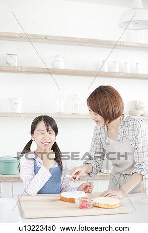 Mother and daughter in kitchen decorating cake, Hyogo Prefecture, Honshu, Japan View Large Photo Image Stock Image - Mother and daughter in kitchen decorating cake, Hyogo Prefecture, Honshu, Japan. Fotosearch