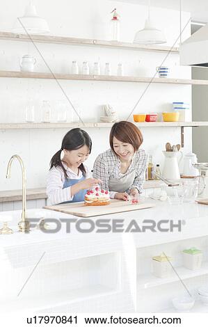 Mother and daughter in kitchen decorating cake, Hyogo Prefecture, Honshu, Japan View Large Photo Image Stock Image - Mother and daughter in kitchen decorating cake, Hyogo Prefecture, Honshu, Japan. Fotosearch
