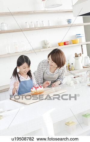 Mother and daughter in kitchen decorating cake, Hyogo Prefecture, Honshu, Japan View Large Photo Image Stock Image - Mother and daughter in kitchen decorating cake, Hyogo Prefecture, Honshu, Japan. Fotosearch