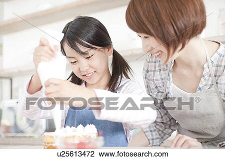 Mother and daughter in kitchen decorating cake, Hyogo Prefecture, Honshu, Japan View Large Photo Image Stock Image - Mother and daughter in kitchen decorating cake, Hyogo Prefecture, Honshu, Japan. Fotosearch
