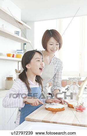 Mother and daughter in kitchen decorating cake, Hyogo Prefecture, Honshu, Japan View Large Photo Image Stock Photo - Mother and daughter in kitchen decorating cake, Hyogo Prefecture, Honshu, Japan. Fotosearch