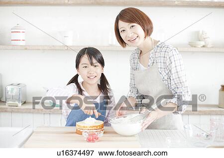 Mother and daughter in kitchen decorating cake, Hyogo Prefecture, Honshu, Japan View Large Photo Image Stock Photo - Mother and daughter in kitchen decorating cake, Hyogo Prefecture, Honshu, Japan. Fotosearch