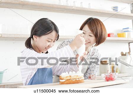 Mother and daughter in kitchen decorating cake, Hyogo Prefecture, Honshu, Japan View Large Photo Image Stock Photography - Mother and daughter in kitchen decorating cake, Hyogo Prefecture, Honshu, Japan. Fotosearch